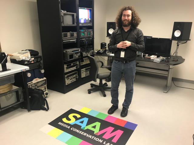 Person stands in from of video machines and monitors